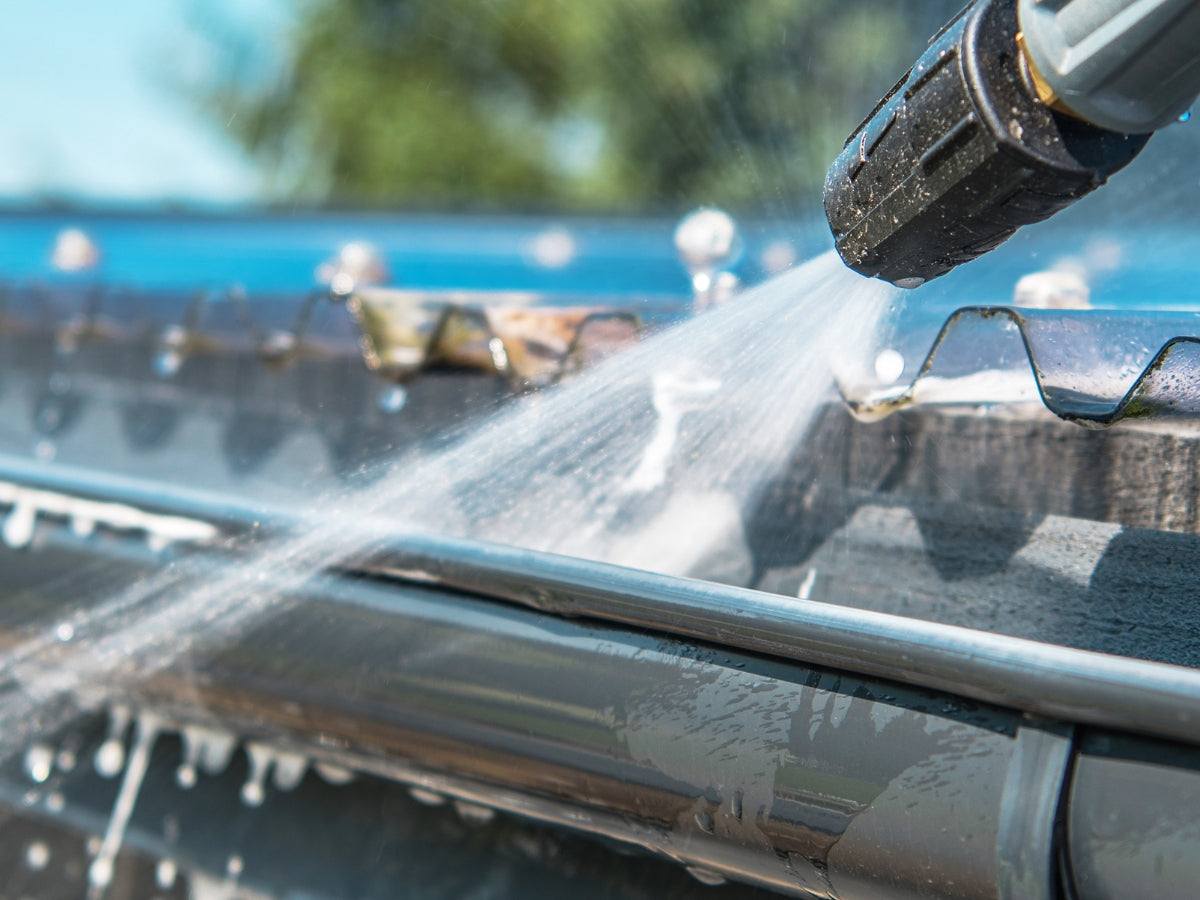 Sparkling clean windows and debris-free gutters on a residential home, highlighting the effectiveness of professional window and gutter cleaning services.